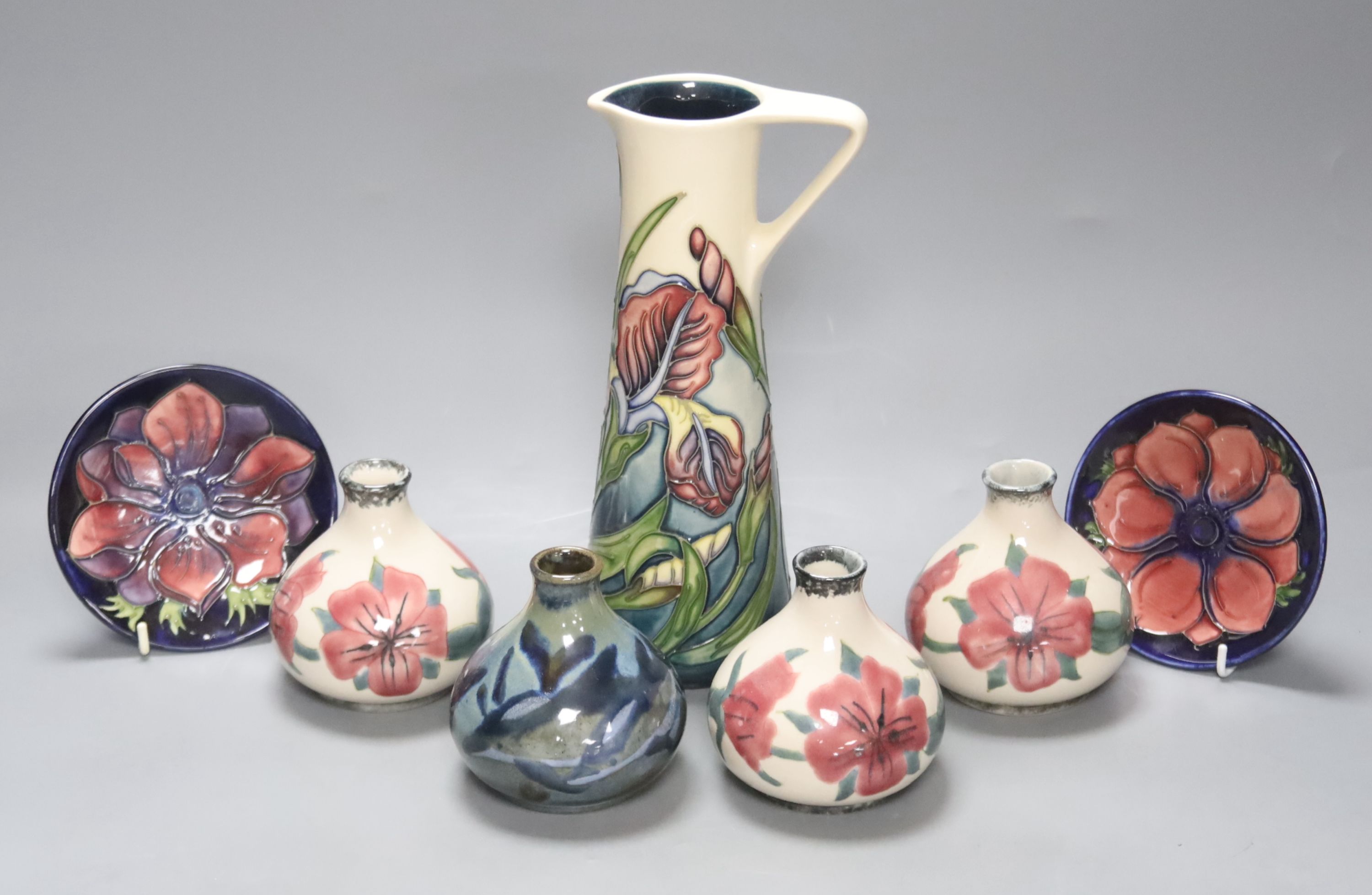 A Moorcroft iris pattern jug and two anenome dishes, together with four Cobridge vases